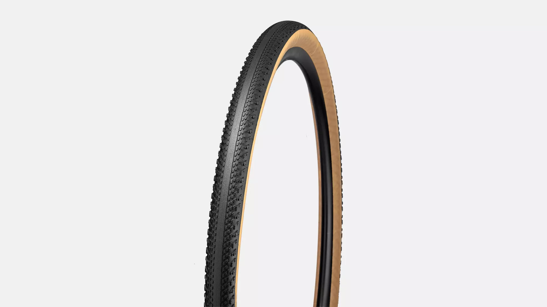 Specialized Pathfinder gravel tire with black tread and tan sidewalls on white background