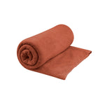 Sea To Summit Tek Towel partially rolled up showing microfiber texture in desert brown color