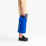 Person holding blue Sea To Summit Lightweight Dry Bag with brand logo