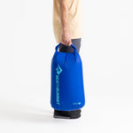Sea To Summit Lightweight Dry Bag in blue held by person