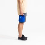 Person holding blue Sea To Summit lightweight dry bag while wearing gray shorts