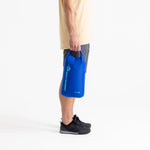 Sea To Summit blue lightweight dry bag held by person in studio