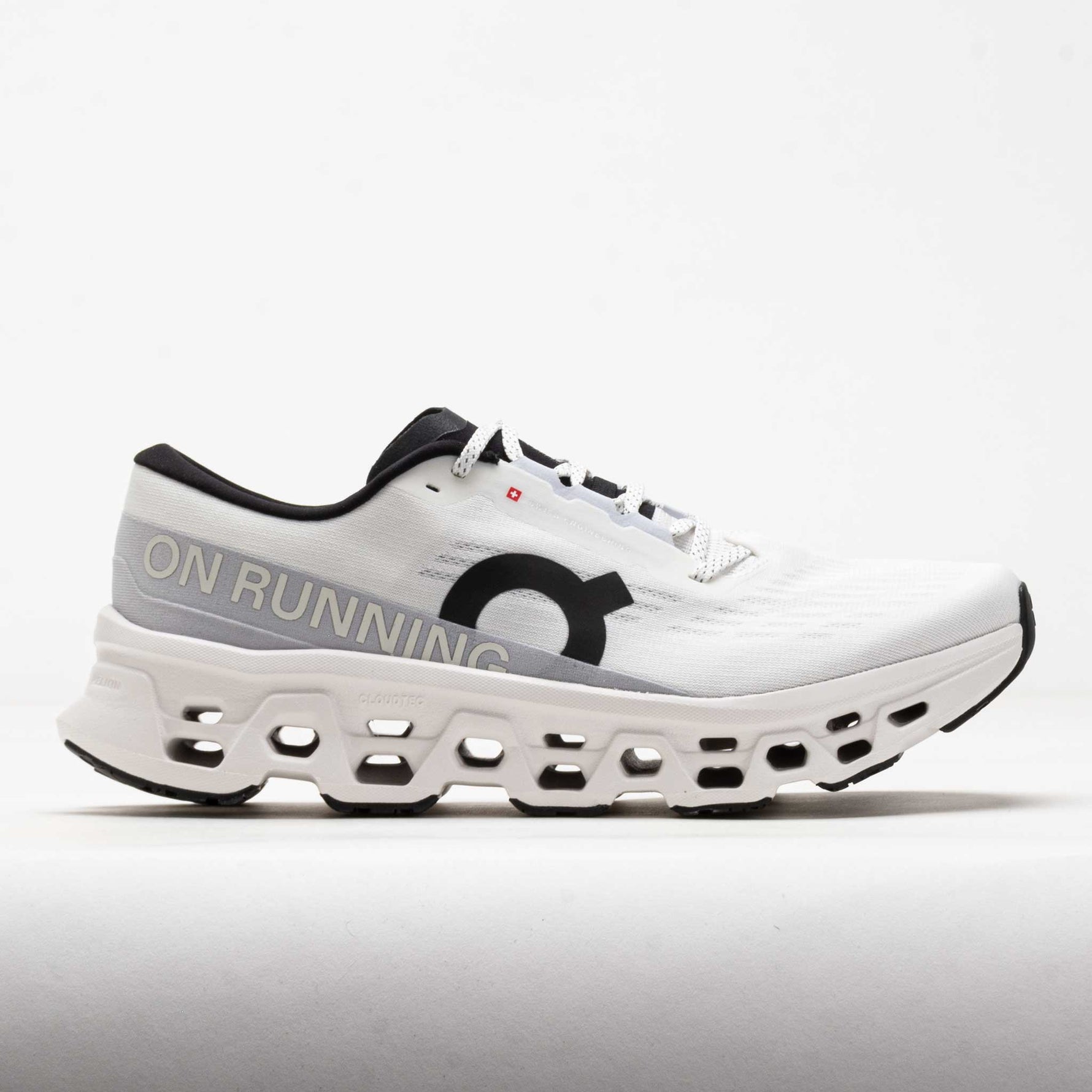 On Cloudmonster running shoe in white with distinctive perforated sole technology