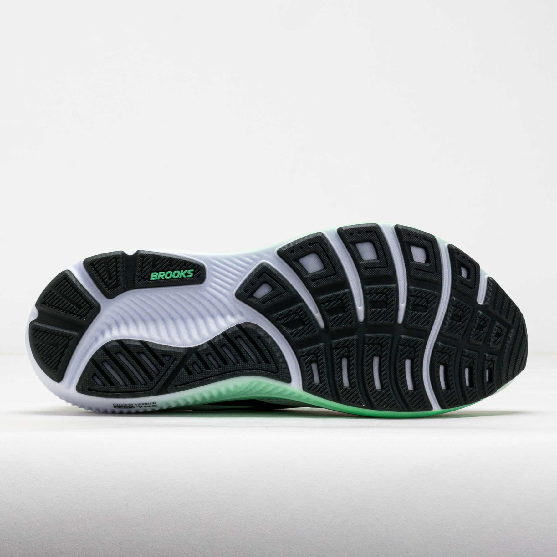 Brooks Ghost 18 running shoe sole view showing white midsole with green and black tread pattern