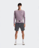 Male model wearing On Speed Belt in fog color over athletic long-sleeve and shorts