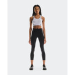 Woman wearing On Running Performance Tights 7/8 in black with white sports bra