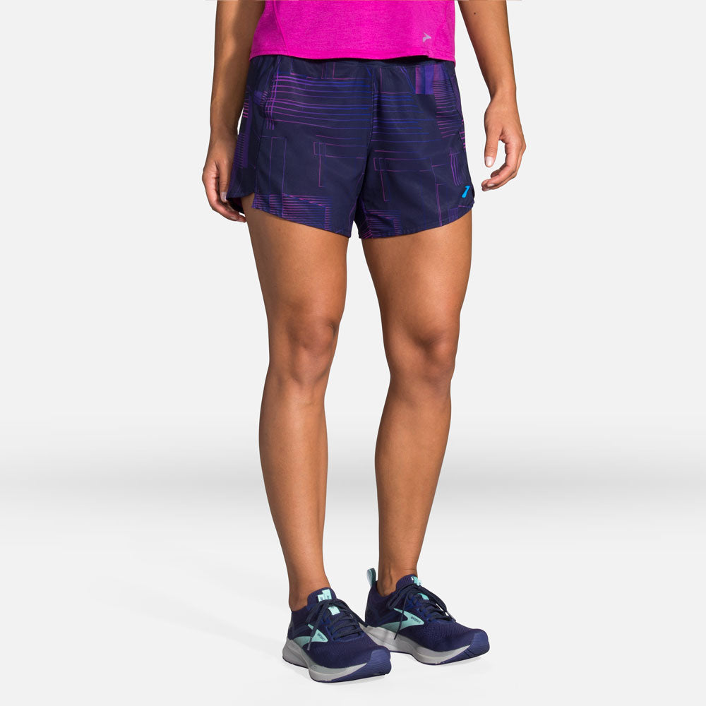 Woman wearing Brooks Chaser 5-inch running shorts in navy with violet geometric pattern