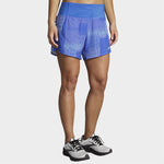 Woman wearing blue Brooks Chaser 5-inch running shorts with high waistband