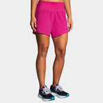 Woman wearing bright pink Brooks Chaser 5-inch running shorts with high waistband