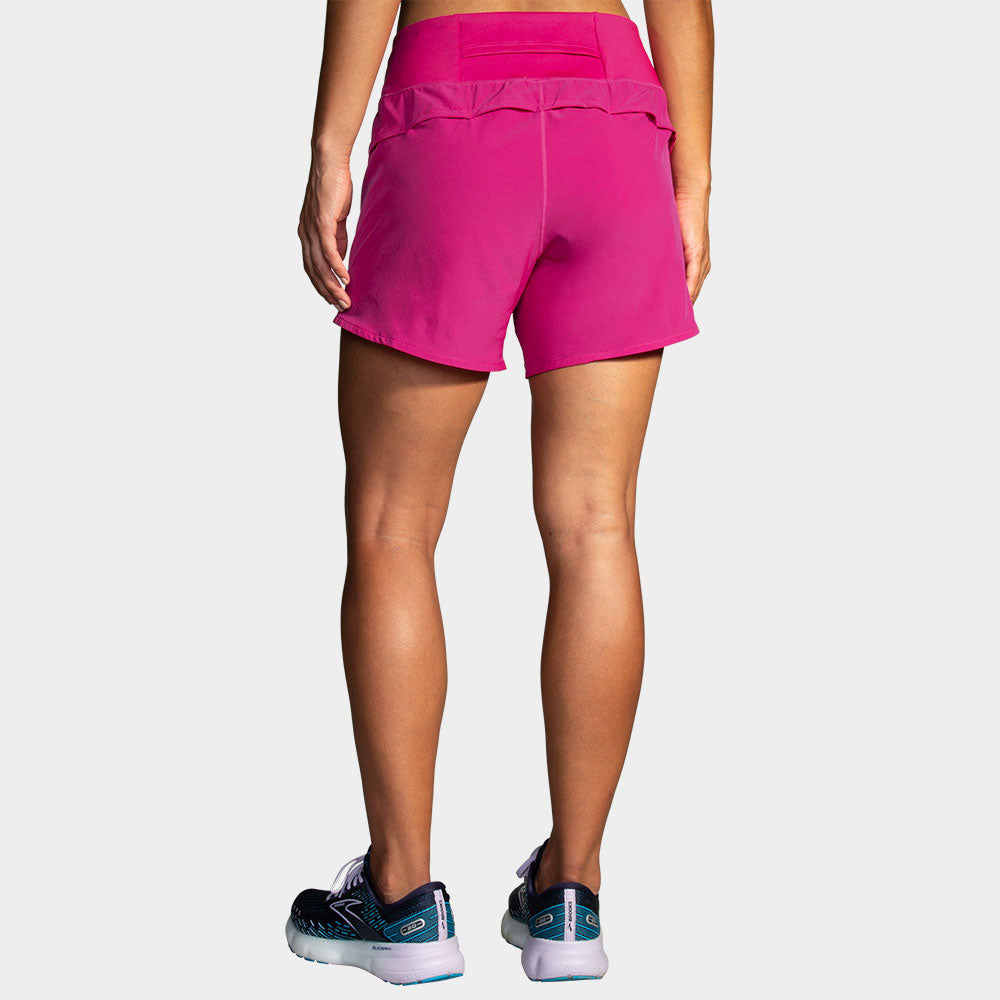 Brooks Chaser 5 inch women's running shorts in bright magenta pink, back view