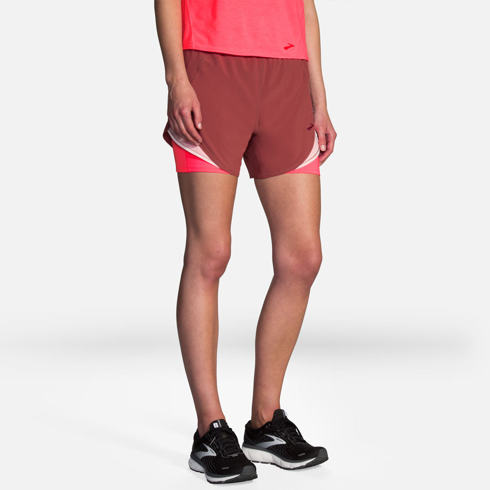 Woman wearing Brooks Chaser 5 inch 2-in-1 running shorts in mauve color