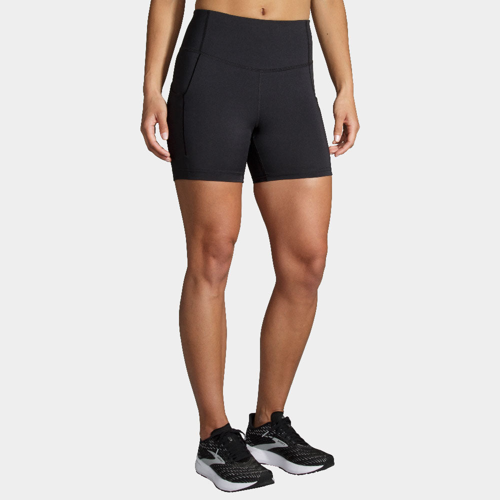 Woman wearing black Brooks Method 5-inch short tights with high waistband and black sneakers