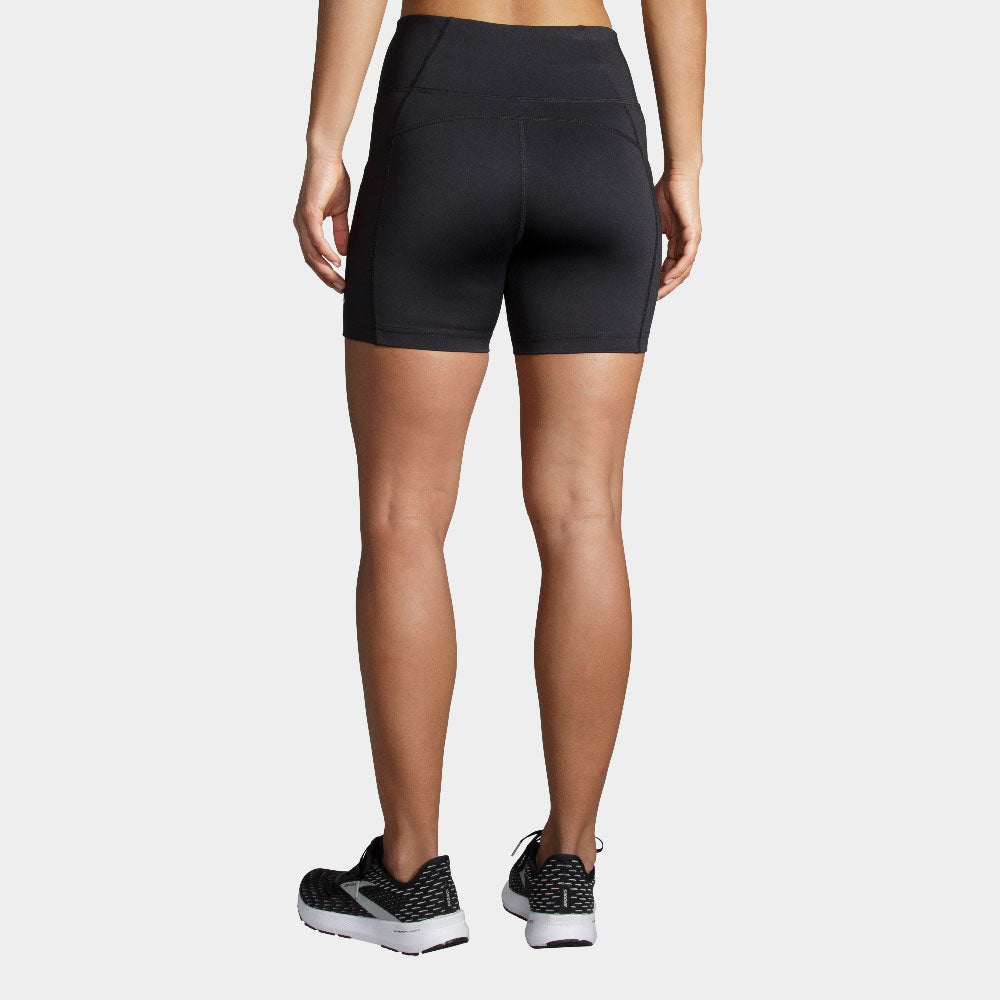 Woman wearing black Brooks Method 5-inch athletic shorts, rear view showing fit
