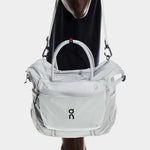 On Track Pack 35L Lite unisex duffel bag in light gray carried by model