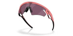 Oakley Sphaera sunglasses with coral pink frame and dark purple lenses