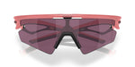 Oakley Sphaera sunglasses with coral pink frame and dark purple lenses on white background