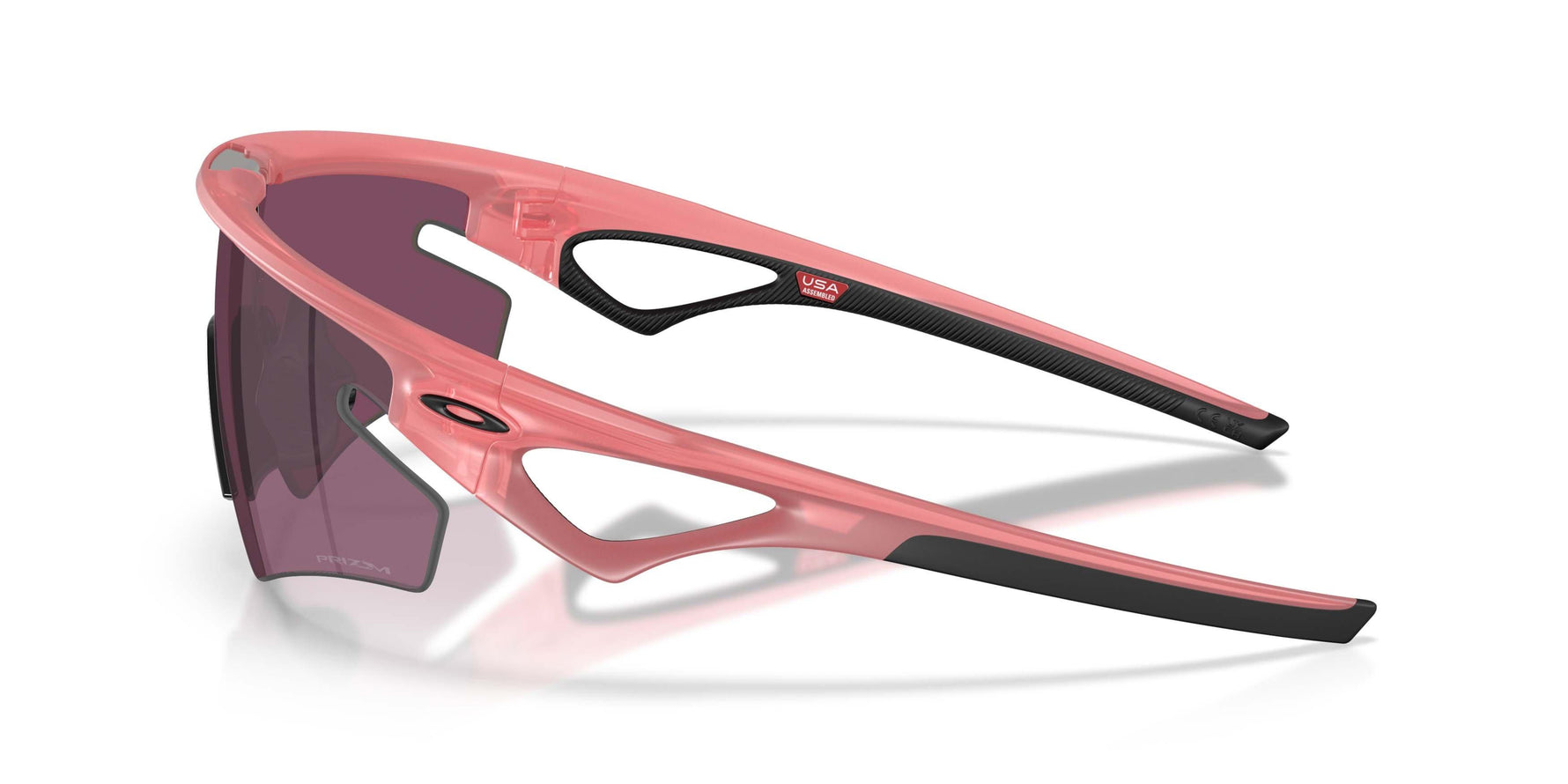 Oakley Sphaera sunglasses in coral pink frame with dark lenses, side profile view