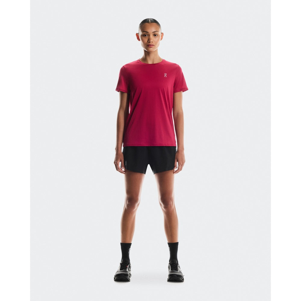 Woman wearing On Running Core-T shirt in grenadine red with black shorts