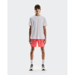 Man wearing white On Focus-T t-shirt with coral shorts and sneakers
