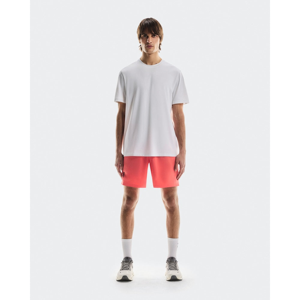 Man wearing white On Focus-T t-shirt with coral shorts and sneakers