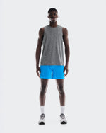 Athletic man wearing On 5-inch Performance Shorts in bright blue with gray tank top