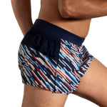 Brooks Sherpa 3-inch Split Short in Motion Print with navy waistband, side view on model