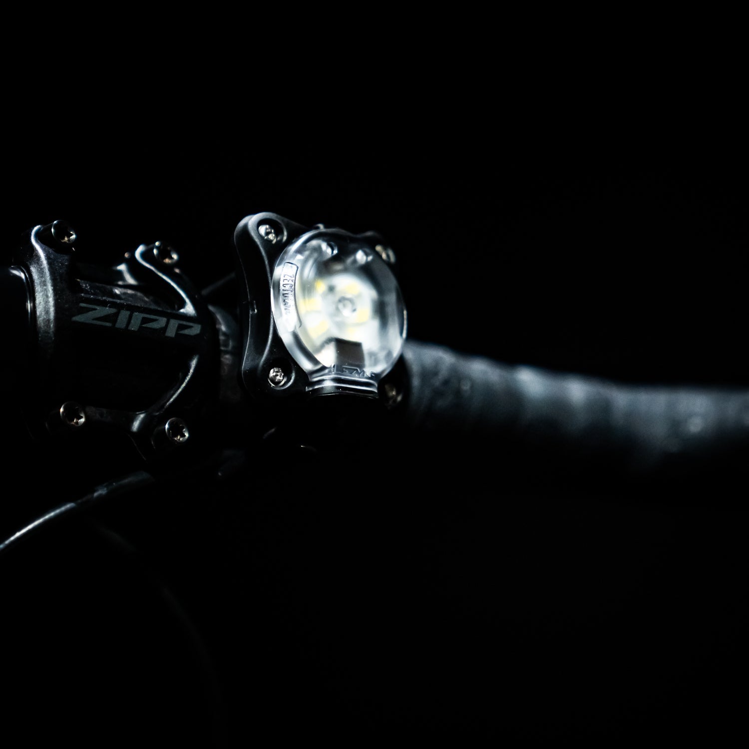 Lezyne Zecto Drive bike light mounted on handlebar with bright beam