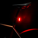 Lezyne Zecto Drive Max 400 rear bike light glowing red in darkness on seatpost