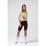 Woman wearing Gobik Attitude 2.0 cycling jersey with colorful geometric pattern and black shorts