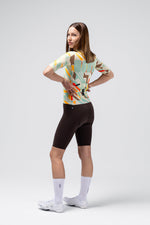 Woman wearing Gobik Attitude 2.0 jersey with colorful geometric Exa pattern and black shorts