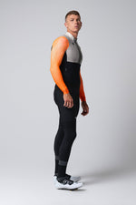 Man wearing Gobik Hyder Blend long sleeve cycling jersey in orange and gray colorway
