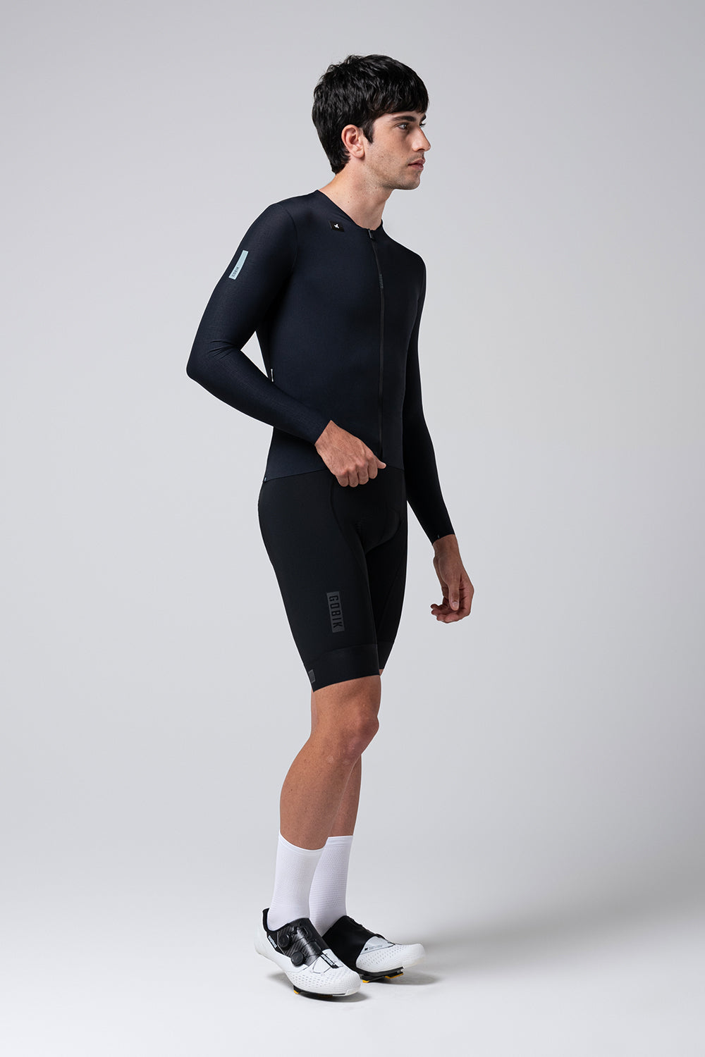 Man wearing black Gobik Avalon Ink long sleeve cycling jersey with shorts