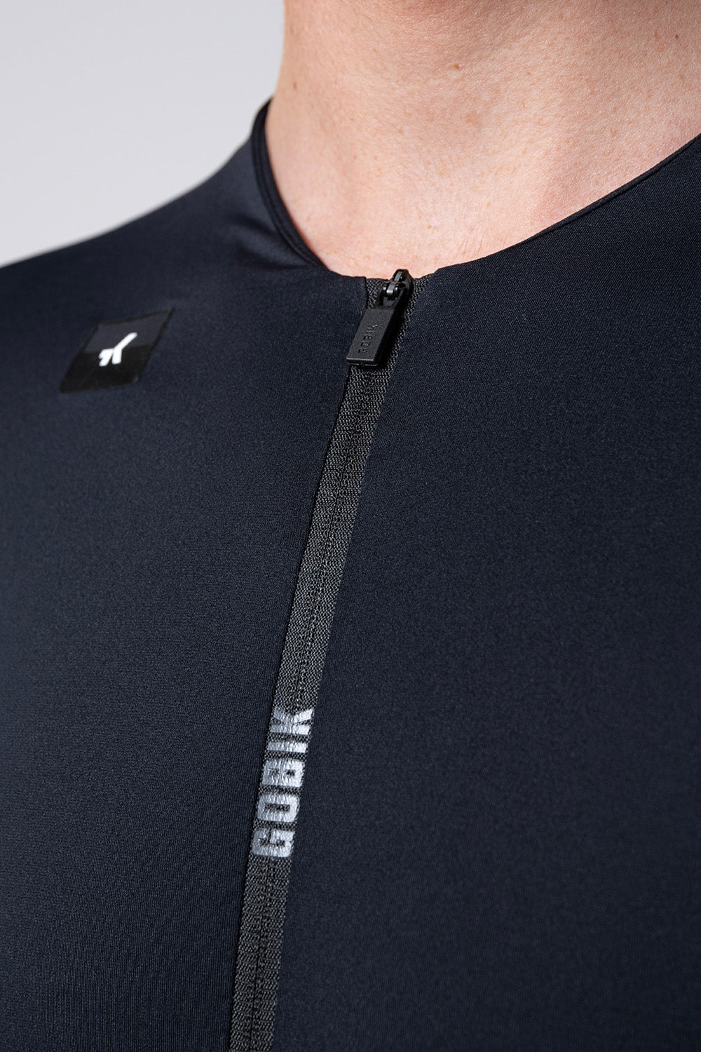 Close-up of Gobik Avalon cycling jersey showing black fabric and zipper detail