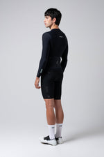 Male model wearing black Gobik Avalon Ink long sleeve cycling jersey in studio