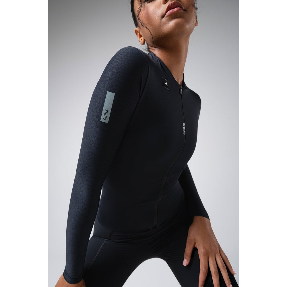 Woman wearing black Gobik Avalon long sleeve cycling jersey with quarter zip