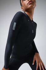 Woman wearing black Gobik Avalon long sleeve cycling jersey with zipper