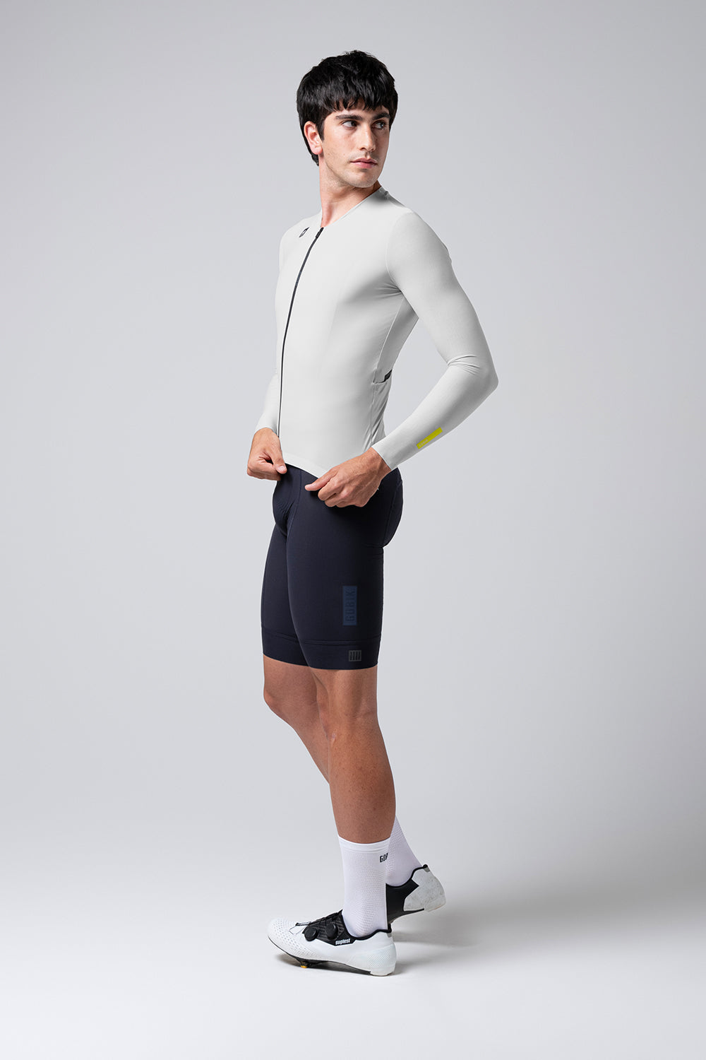 Male model wearing Gobik Avalon Ink long sleeve cycling jersey in oatmeal color