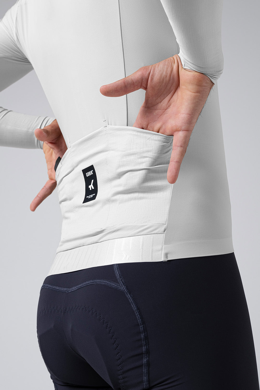 Model wearing Gobik Avalon Ink long sleeve cycling jersey in oatmeal color