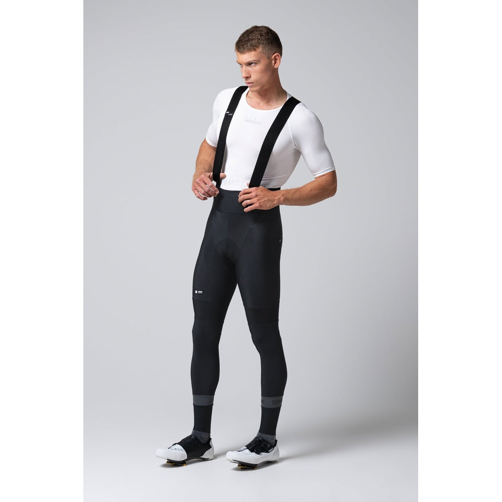 Male model wearing black Gobik Absolute 7.0 bib shorts with white jersey