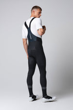 Man wearing black Gobik Absolute 7.0 bib shorts with suspenders, rear view