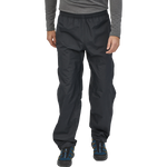 Man wearing black Patagonia Torrentshell 3L rain pants with elastic waist