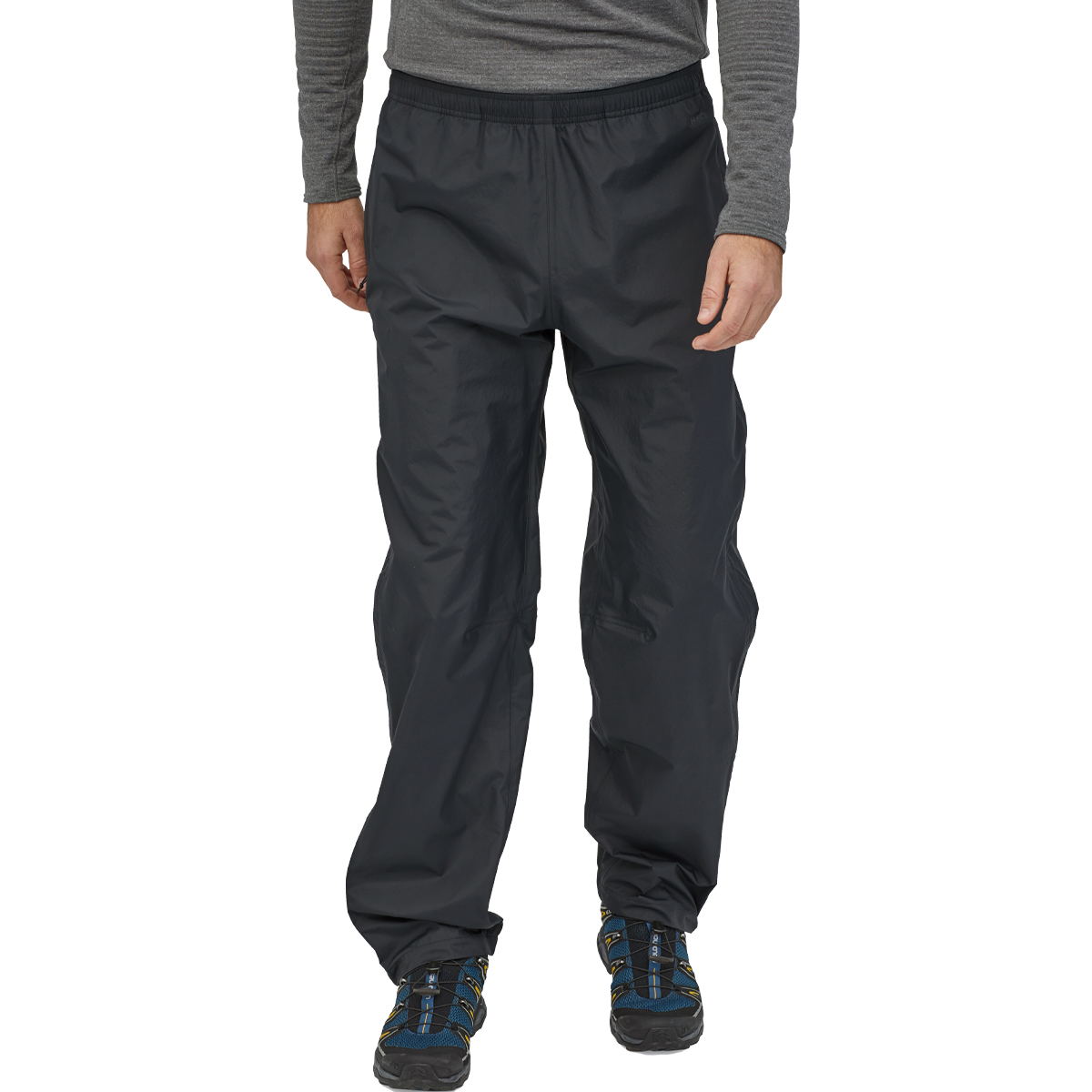 Man wearing black Patagonia Torrentshell 3L rain pants with elastic waist