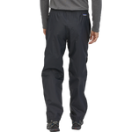 Man wearing black Patagonia Torrentshell 3L waterproof pants with elastic cuffs