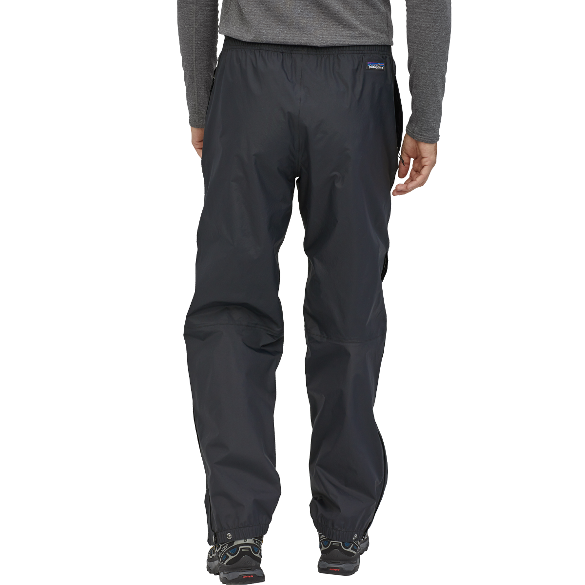 Man wearing black Patagonia Torrentshell 3L waterproof pants with elastic cuffs