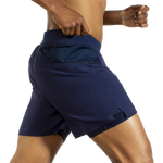 Man wearing Brooks Sherpa navy blue athletic shorts with built-in liner