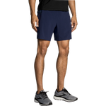Man wearing Brooks Sherpa navy blue athletic shorts with running shoes