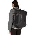 Woman wearing black Patagonia Black Hole Mini MLC backpack from behind