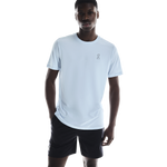 Man wearing light blue On Core-T shirt with black shorts on white background