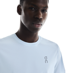 Man wearing white On Core-T shirt with On logo on chest