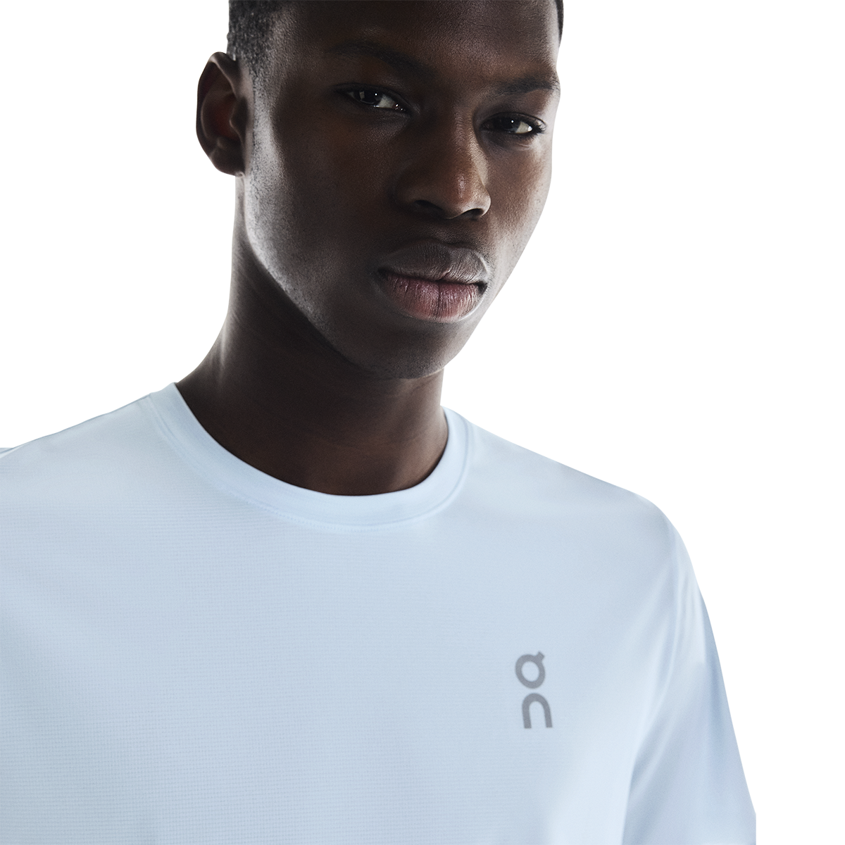 Man wearing white On Core-T shirt with On logo on chest